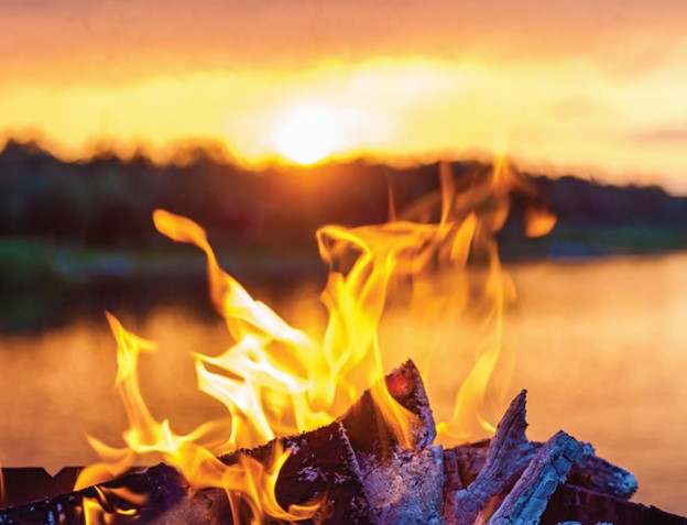 Campfire at sunset by the lake.